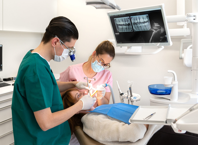 Promoting Oral Health: highlighting oral health and professional dental care for assignment help A dentist and two women in a dental office, highlighting oral health and professional dental care for Dentistry Homework Help
