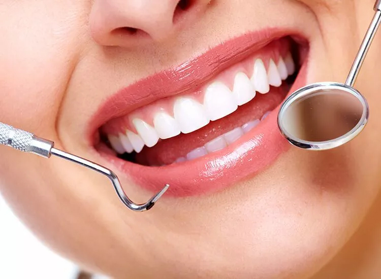 The Importance of Oral Health: connection between oral care and dentistry for homework help An image depicting a woman with a dental instrument in her mouth, highlighting the connection between oral care and dentistry