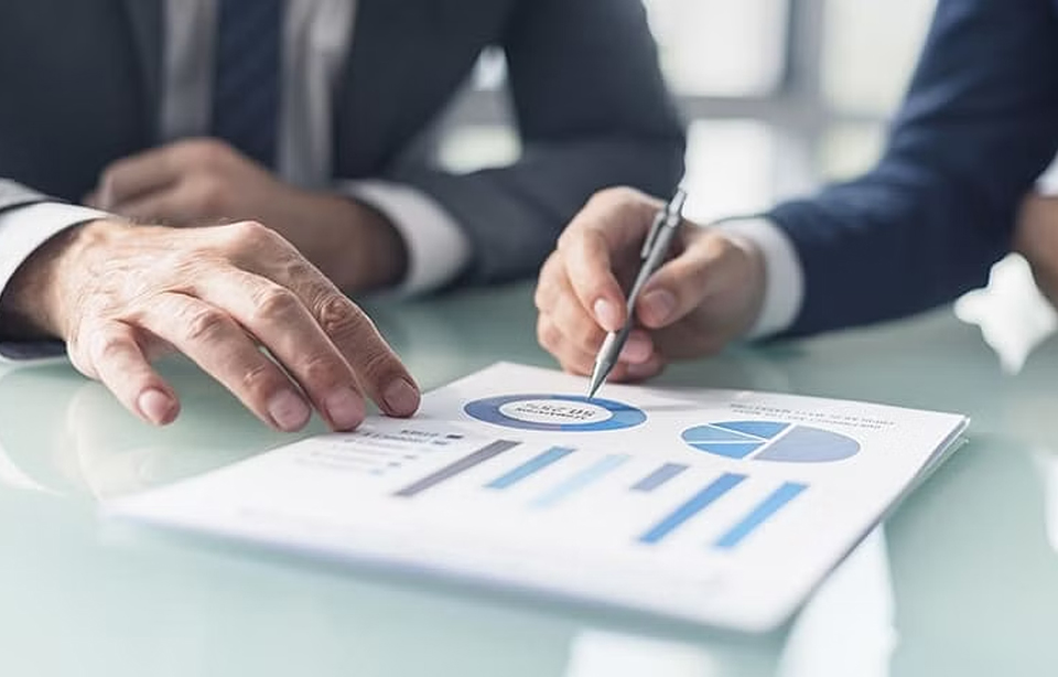 Business Plan Discussion: Seeking Homework and Assignment Assistance Business students in professional attire discussing a business plan, seeking assistance with homework and assignments