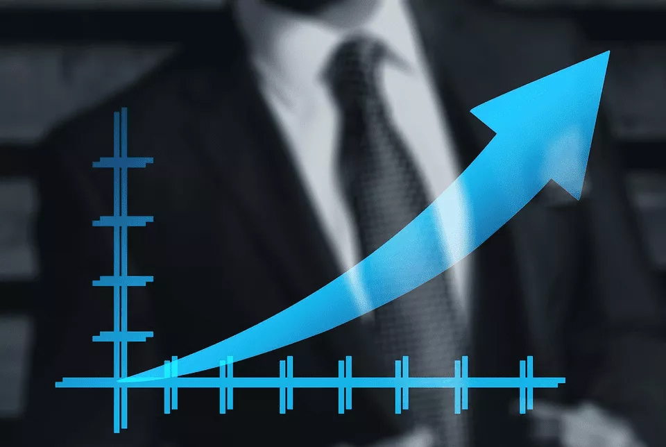 Economic Growth in Focus: Analyzing Trends for Economics Homework A man in a suit holding a graph with an upward arrow, representing Economics Homework Help concept