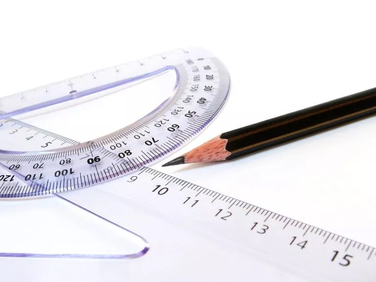 Geometry Essentials: Tools for Homework Success A ruler, pencil, and protractor on a white surface - essential tools for geometry homework help
