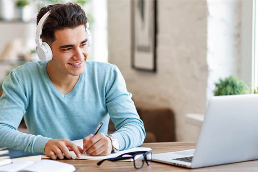 a student is happily engaged in interactive tutoring session a male student is ready to take his tutoring session online