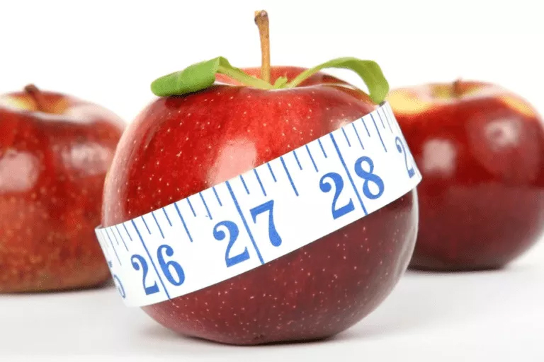 Measuring the Essence of Apples: Exploring Measure Theory Fresh apples with a measuring tape wrapped around them, representing a Measure Theory Assignment Help concept