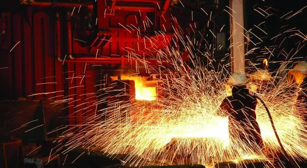 A worker skillfully welds steel in a factory, showcasing the metallurgy homework concept A worker skillfully welds steel in a factory, showcasing the Metallurgy Homework Help