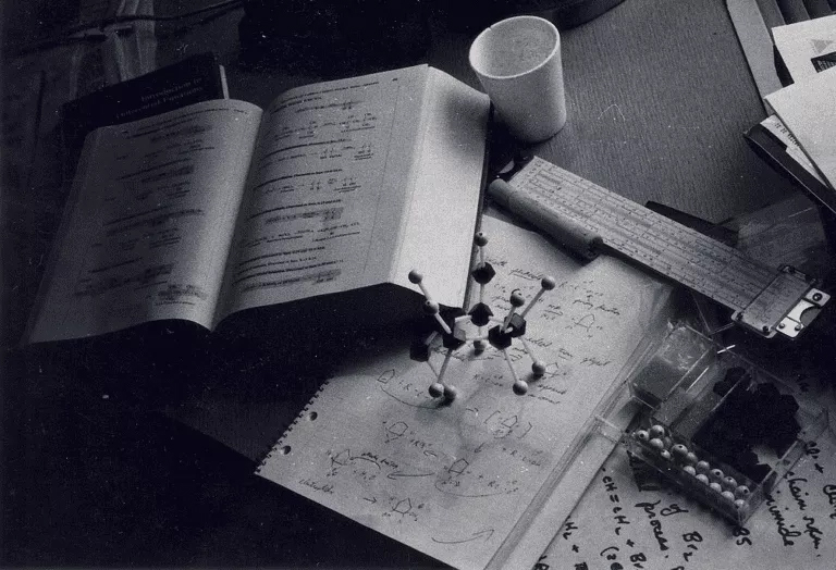 a monochrome image indicates the topics related to organic chemistry homework help A monochrome image of a desk cluttered with papers and a cup representing organic chemistry homework help