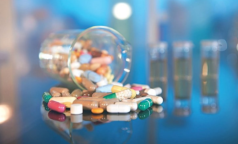 A glass jar filled with pills and other medications indicates the pharmaceutics assignment concept A glass jar filled with pills and other medications, representing pharmaceutics assignment help
