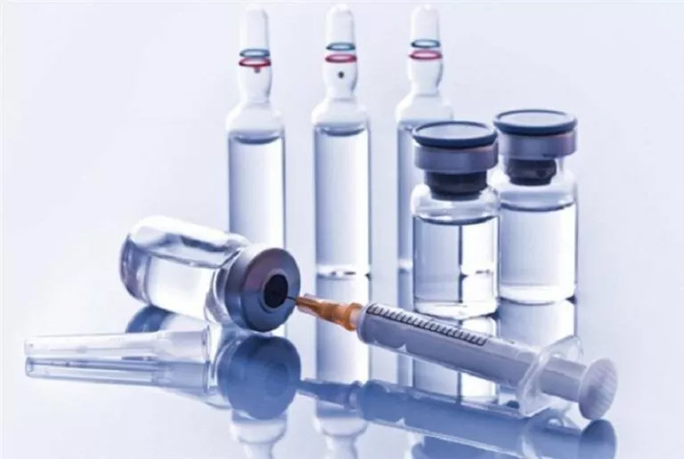 Pharmacy Homework Help: Vaccine Administration Essentials Vaccine vials and syringes neatly arranged on a table. Image depicts pharmacy homework help
